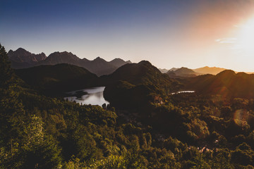 European mountain sunset overlooking forest, valley and lake.