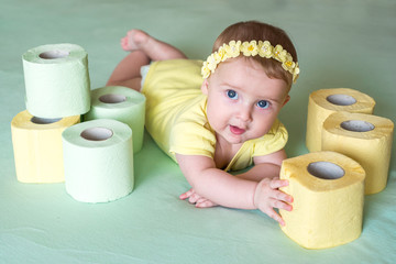 A Toddler ripping up toilet paper in bathroom studio