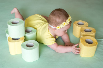 A Toddler ripping up toilet paper in bathroom studio