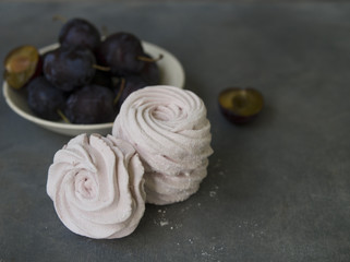 Homemade plum marshmallows on gray background. Russian pink zephyr. Selective focus. Close up, copy space