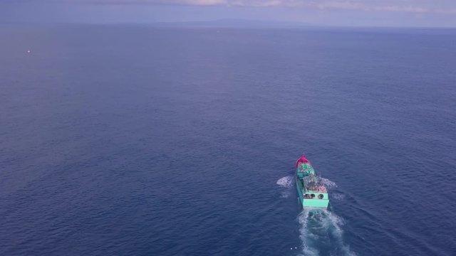 Aerial view of indonesian phinisi boat crossing benoa bay at bali indonesia