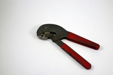 Crimping pliers, old used, on white background