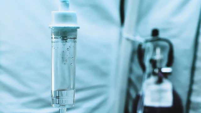 Close up shot of a drop chamber on an intravenous tube in a medical facility