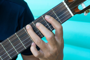 Man hand on playing guitar