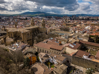 Aerial panorama view of fortified medieval Pamplona cathedral in Spain with dramatic cloudy blue sky