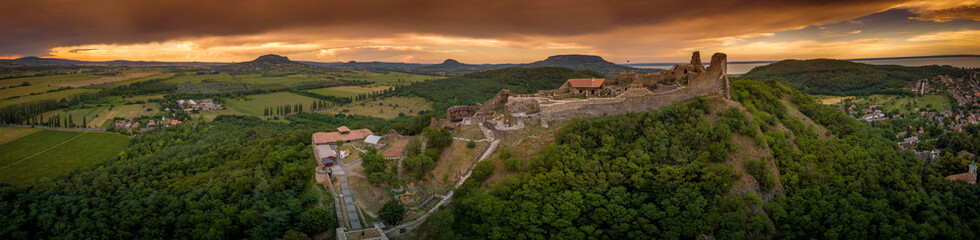 Aerial sunset panorama of ruined medieval Szigliget castle in Hungary above the Lake Balaton with...