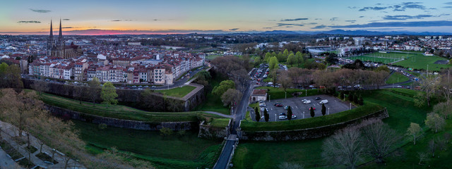 Aerial panorama sunrise with orange sky over the fortified french town of Bayonne with cathedral view