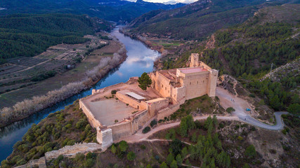 Aerial view of Miravet templar crusader castle and ebro river province of tarragona Spain. Miravet is one of the most picturesque villages in Spain.