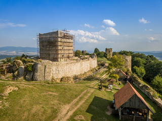 Aerial view of ruined medieval Saros castle with a donjon, walls, towers  in Slovakia