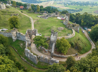 Aerial panorama of ruined medieval Saris castle in Slovakia with round towers, donjon, walls, and blue sky background