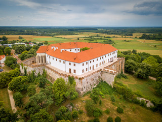 Aerial panorama of medieval Siklos castle in Hungary with brick walls, barbican, towers and Gothic chapel and stormy blue sky