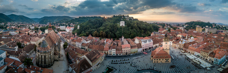 Brasov cityscape aerial view with balck church, white tower, red roofs in Romania