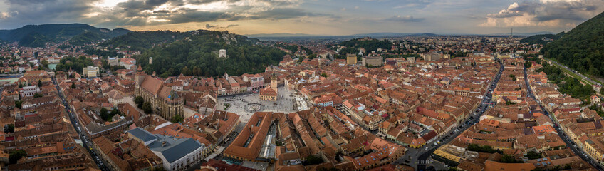 Brasov cityscape aerial view with balck church, white tower, red roofs in Romania