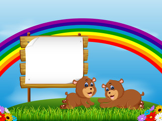 the nature view with the wooden board blank space and two little bear lie down 
