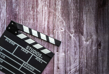 Obraz premium Clapperboard on wooden background.mock up, top view. Flat lay of cinema items.