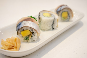 Saba sushi roll on white plate