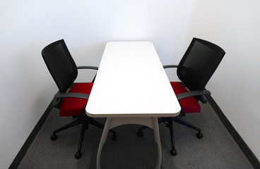 table and two chairs inside the meeting room