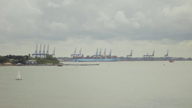 Harbour in Hoek van Holland, with Sailing boat on Foreground and large Container ship in Background.