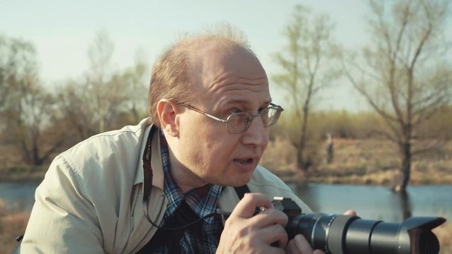 Photographer travel and takes pictures in nature.