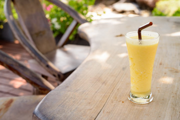Refreshing And Healthy Mango Smoothie On Wooden Table