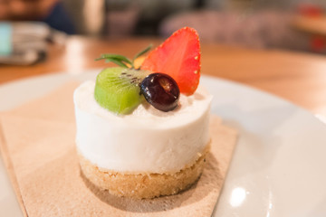 cheesecake with fresh strawberries  kiwi and blueberry for dessert. soft focus