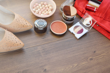 Women's accessories (scarf, blue lacquered shoes, perfume and beads on a wooden background 