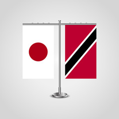 Table stand with flags of Japan and Trinidad and Tobago.Two flag. Flag pole. Symbolizing the cooperation between the two countries. Table flags