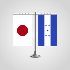 Table stand with flags of Japan and Honduras.Two flag. Flag pole. Symbolizing the cooperation between the two countries. Table flags
