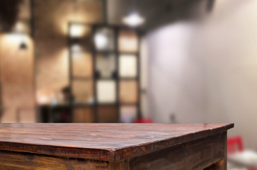 Selected focus empty brown wooden table and Coffee shop or restaurent blur background with bokeh image. for your photomontage or product display