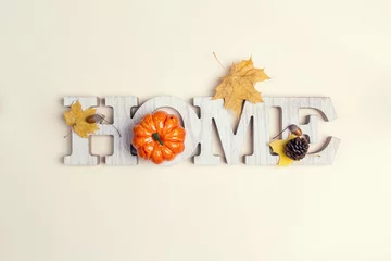Foto op Plexiglas Decorative word Home with pumpkin and fallen leaves on on beige background. Copy space for text. © WindyNight