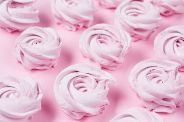 a lot of marshmallows, homemade apple pink marshmallows lined on a pink background, dessert concept, macro photography