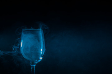 Wine glass filled with smoke on a black background