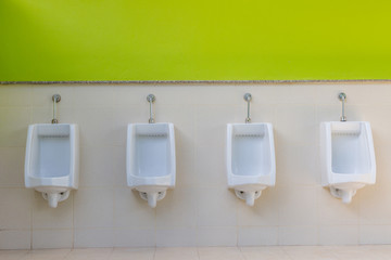 white urinals in men's bathroom, design of white ceramic urinals for men in toilet room