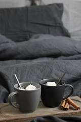 Two coffee mug in dark grey bed