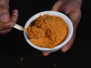 Turmeric powder and fresh turmeric on wooden background, Turmeric Powder in White Bowl on Wooden Background,Turmeric Powder in Spoon, Haldi , Haladi Powder Called in India, Turmeric