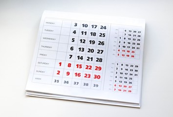 White calendar. Weekends are highlighted in red. Close up