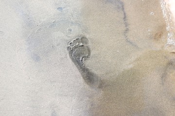 Human footprint on the beach sand.