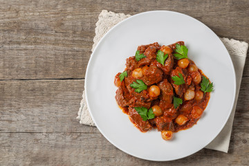 A traditional Greek dish of beef stifado in a sauce. The view from the top. Copy-space.