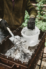 Cleaning the metal forged brazier in the yard