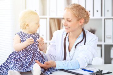 Doctor and patient in hospital. Little girl is being examined by pediatrician with stethoscope. Medicine and health care