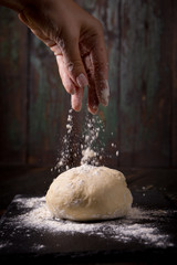 hand pours flour