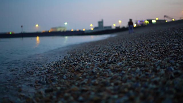 a couple on a rocky beach near dover england.