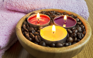 Obraz na płótnie Canvas candle lights with coffe beans for spa and christmas decoration concept