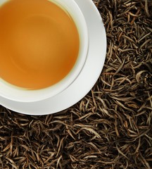 Cup of White Tea on the Dried White Tea Leaves - Top View