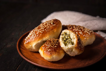 Baked pies with cheese and spinach