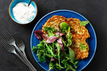 Comfort food Fried zucchini pancakes served plate salad top view