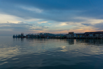 Thai traditional fishing boats are parking at jetty (Sattihip Bay) in a evening day