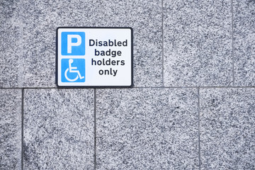 Fototapeta premium Disabled Badge Holders Only at Car Park Sign on wall