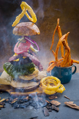 Hamburger with realistic flying ingredients. Tasty smoked grilled and glazed beef burger with...