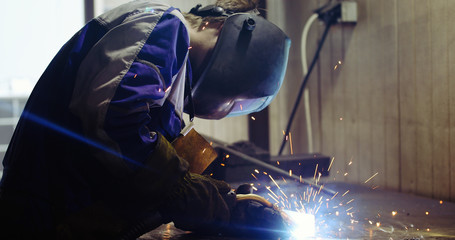 Metal worker welding in metal industry factory